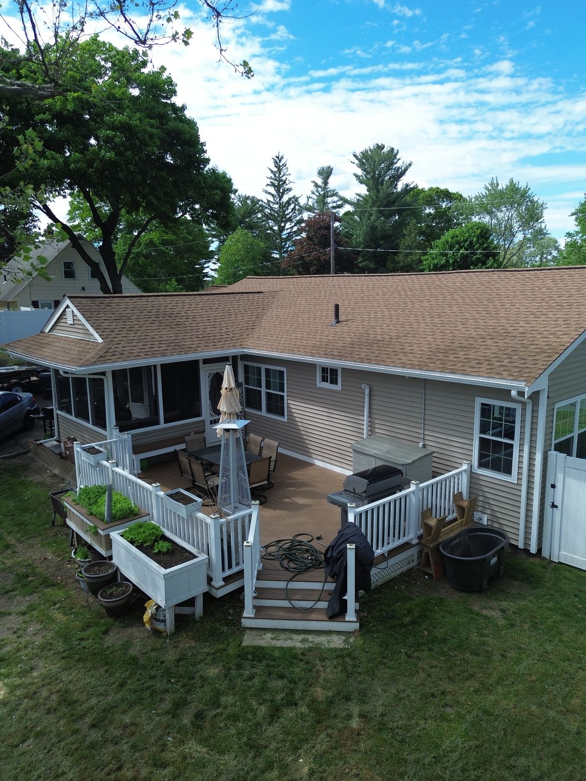 Completed roof and rear deck of a renovated ranch home